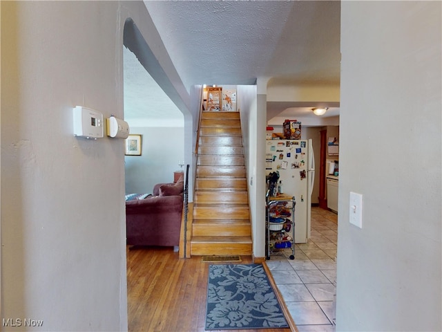 3882 Wallingford Rd, South Euclid, OH 44121 - stairway featuring a textured ceiling