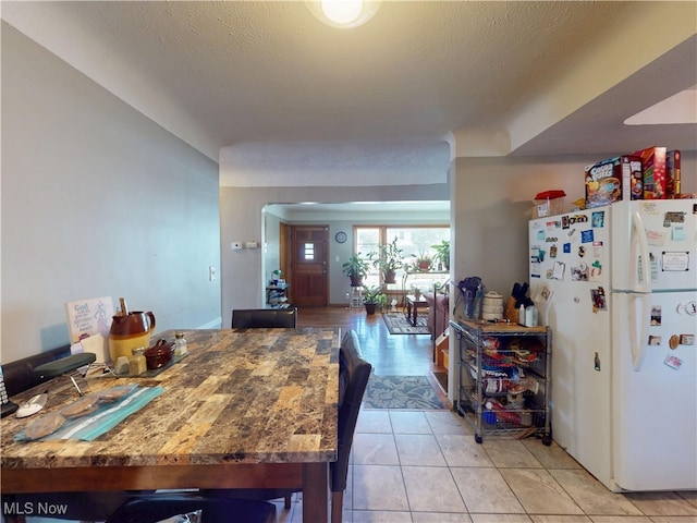 3882 Wallingford Rd, South Euclid, OH 44121 - kitchen with freestanding refrigerator, light tile patterned flooring, and a textured ceiling