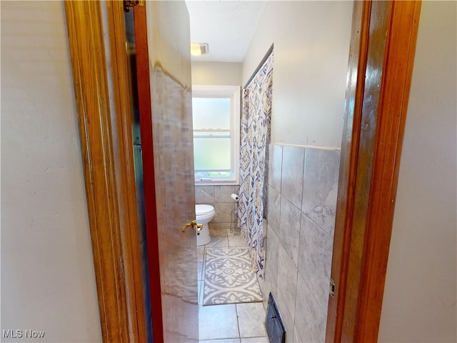 3882 Wallingford Rd, South Euclid, OH 44121 - bathroom with toilet, tile walls, tile patterned flooring, and wainscoting