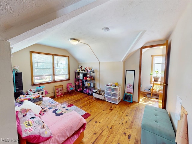 3882 Wallingford Rd, South Euclid, OH 44121 - bedroom with lofted ceiling, light wood-style floors, and a textured ceiling