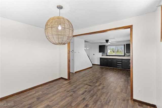 60620 Main St, Jacobsburg, OH 43933 - unfurnished living room with dark wood finished floors, baseboards, and ceiling fan