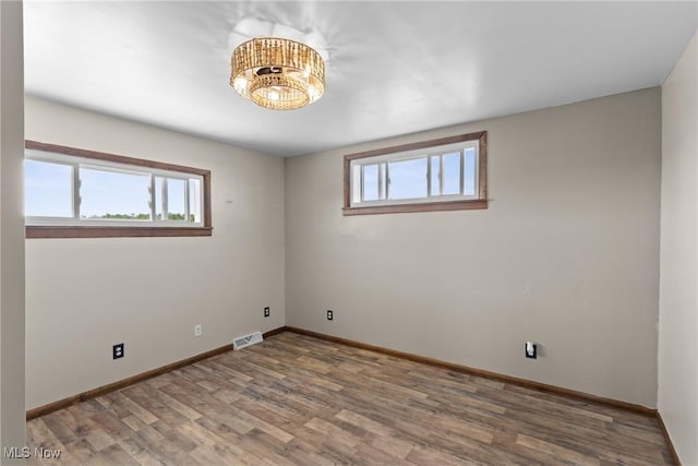 60620 Main St, Jacobsburg, OH 43933 - unfurnished room featuring healthy amount of natural light, wood finished floors, and baseboards