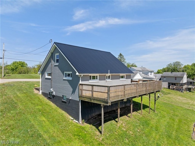 60620 Main St, Jacobsburg, OH 43933 - back of house with a deck, a lawn, and metal roof