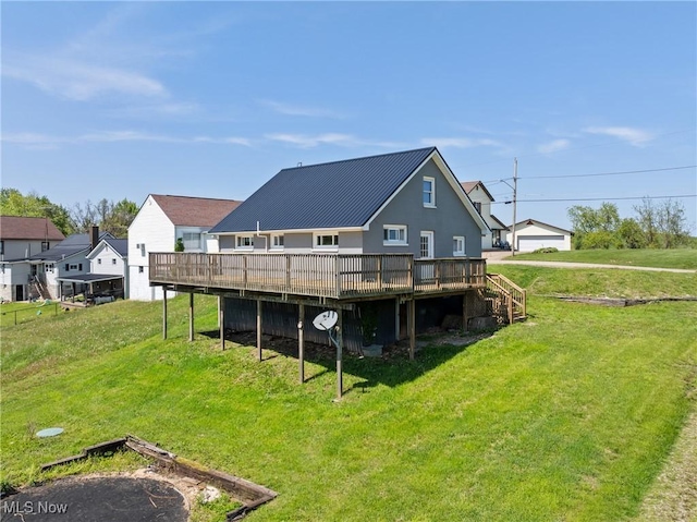 60620 Main St, Jacobsburg, OH 43933 - back of property featuring a deck, a lawn, and metal roof