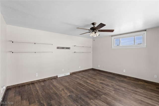 60620 Main St, Jacobsburg, OH 43933 - empty room featuring a ceiling fan, dark wood finished floors, and baseboards