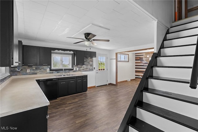 60620 Main St, Jacobsburg, OH 43933 - kitchen featuring dishwasher, dark cabinets, a sink, ceiling fan, and light countertops