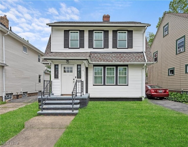 2017 Goodnor Rd, Cleveland Heights, OH 44118 - view of front of house featuring a front yard, a chimney, and roof with shingles