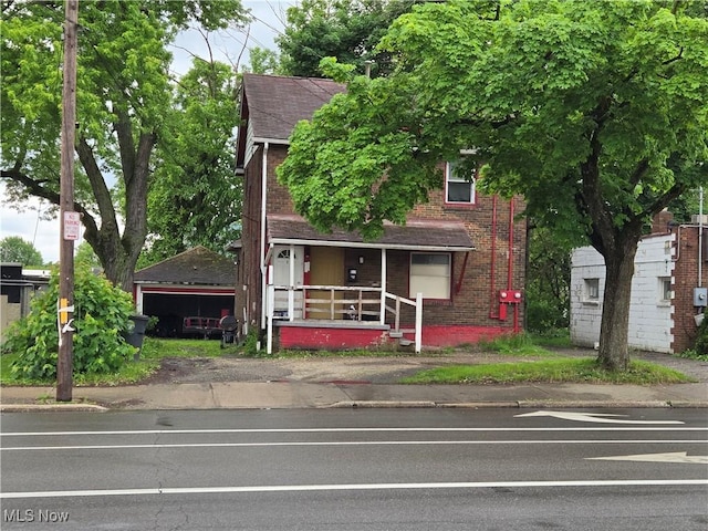 958 E Wilbeth Rd, Akron, OH 44306 - view of front of property with roof with shingles, brick siding, and a porch