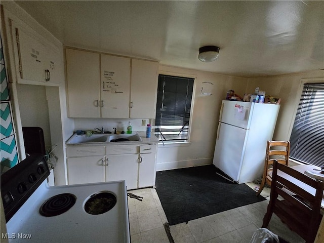 958 E Wilbeth Rd, Akron, OH 44306 - kitchen with white appliances, white cabinets, and light countertops