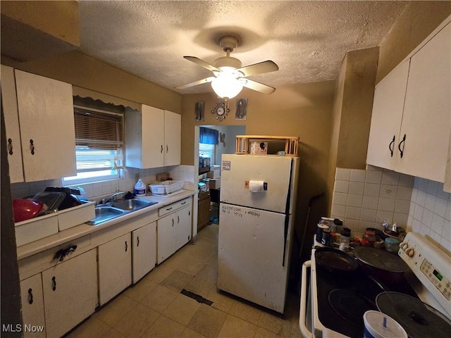 958 E Wilbeth Rd, Akron, OH 44306 - kitchen with white appliances, light countertops, white cabinets, ceiling fan, and a textured ceiling