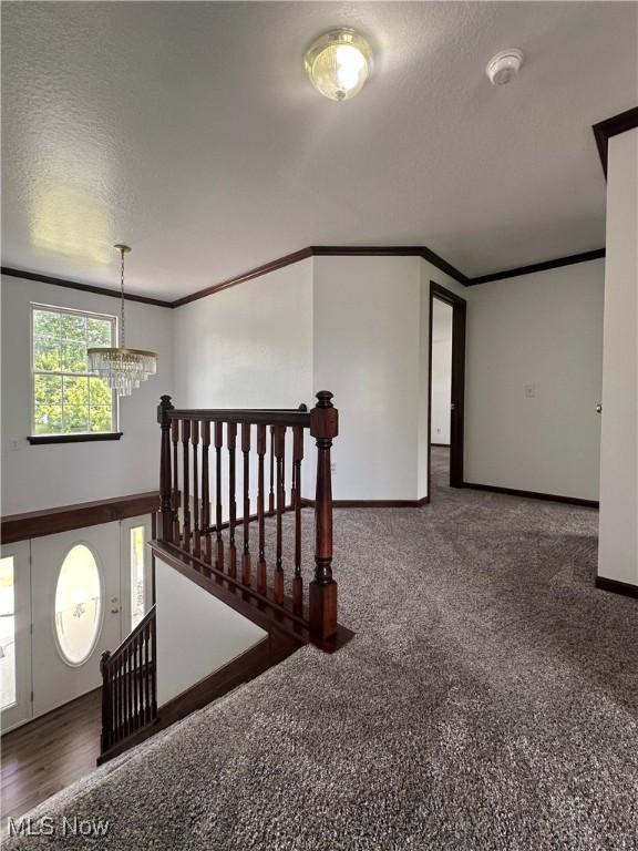 95 Cheyenne Dr, Girard, OH 44420 - empty room with a chandelier, crown molding, a textured ceiling, and a smoke detector