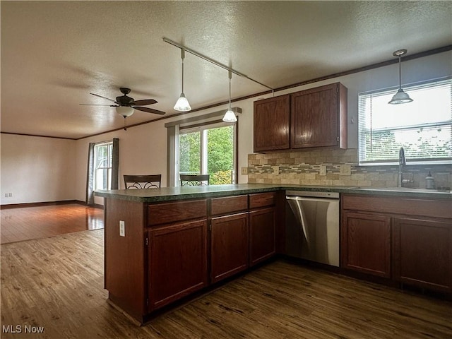 95 Cheyenne Dr, Girard, OH 44420 - kitchen with dishwasher, a textured ceiling, dark countertops, a peninsula, and decorative backsplash