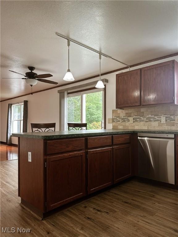 95 Cheyenne Dr, Girard, OH 44420 - kitchen featuring stainless steel dishwasher, dark wood-style floors, plenty of natural light, backsplash, and a textured ceiling