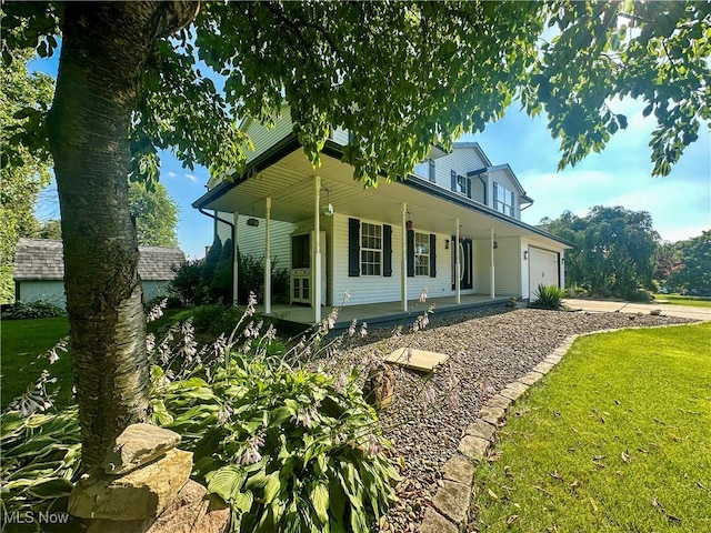 95 Cheyenne Dr, Girard, OH 44420 - farmhouse inspired home with a porch, a garage, concrete driveway, and a front yard