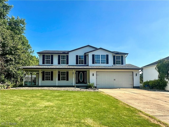 95 Cheyenne Dr, Girard, OH 44420 - view of front of property with driveway, a porch, a front yard, and a garage