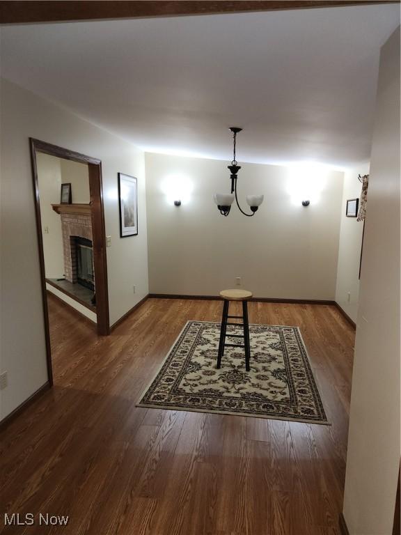 5747 E Clinton St, Albany, OH 45710 - unfurnished dining area featuring wood finished floors, a glass covered fireplace, and baseboards