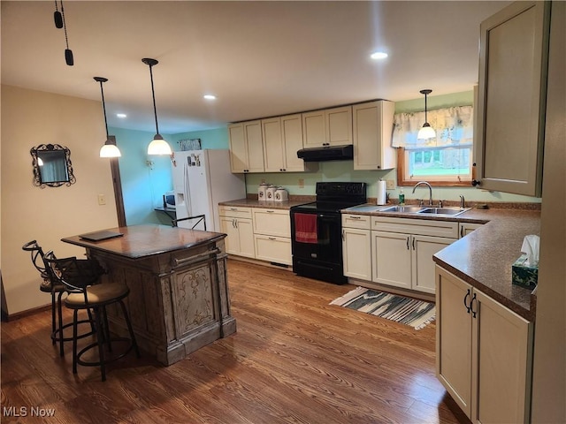 5747 E Clinton St, Albany, OH 45710 - kitchen with electric range, a sink, under cabinet range hood, white fridge with ice dispenser, and dark countertops