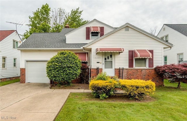 14245 Cedar Rd, South Euclid, OH 44121 - view of front of house featuring brick siding, an attached garage, driveway, a front lawn, and a shingled roof