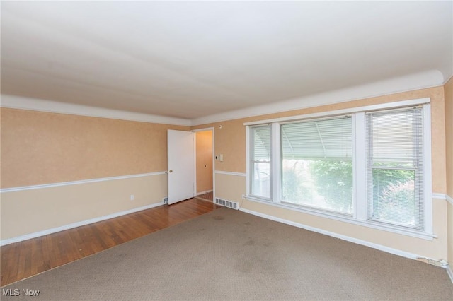 14245 Cedar Rd, South Euclid, OH 44121 - spare room with baseboards, carpet flooring, and wood finished floors