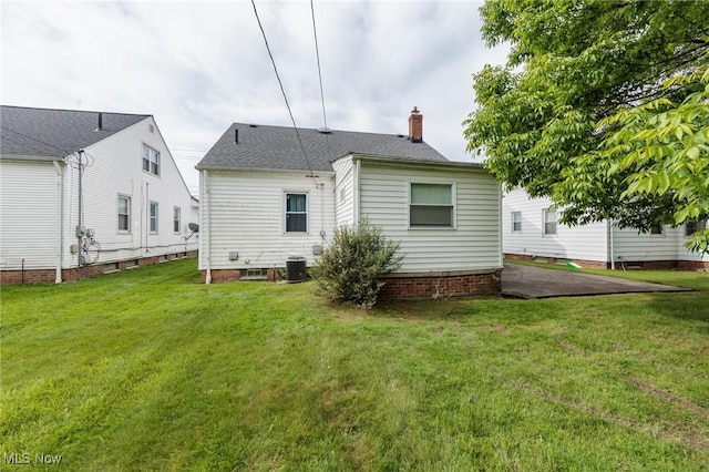 14245 Cedar Rd, South Euclid, OH 44121 - rear view of property with a chimney, a yard, and central air condition unit