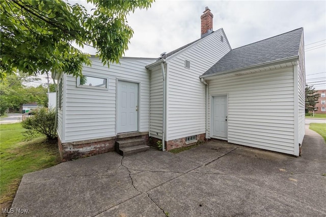 14245 Cedar Rd, South Euclid, OH 44121 - rear view of property with entry steps, a shingled roof, a chimney, and a patio area