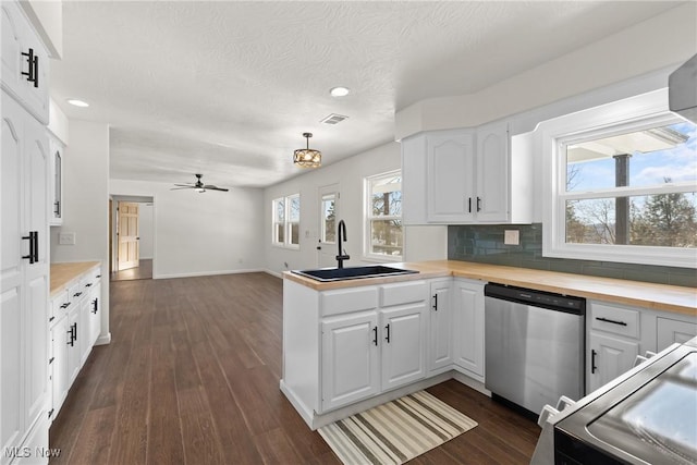47423 Centerville Jacobsburg Rd, Jacobsburg, OH 43933 - kitchen featuring stainless steel dishwasher, a sink, dark wood-type flooring, recessed lighting, and white cabinets
