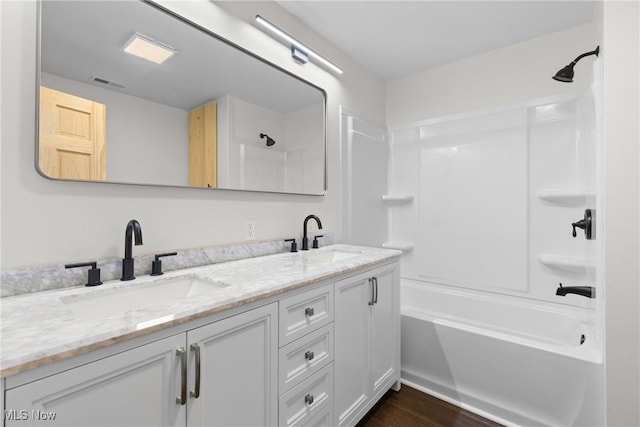 47423 Centerville Jacobsburg Rd, Jacobsburg, OH 43933 - full bath with double vanity, tub / shower combination, and wood finished floors