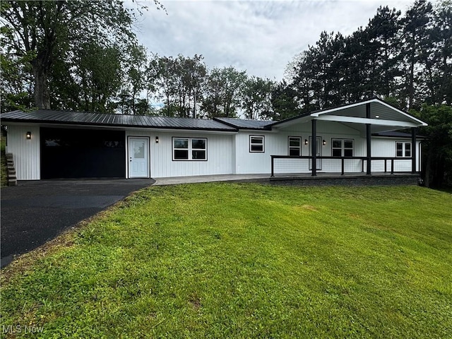 47423 Centerville Jacobsburg Rd, Jacobsburg, OH 43933 - view of front of property featuring a front lawn, driveway, metal roof, and covered porch