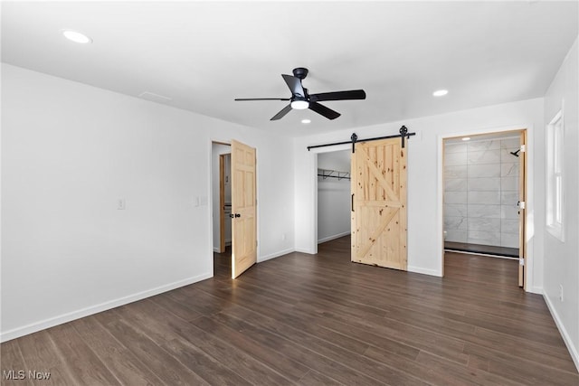 47423 Centerville Jacobsburg Rd, Jacobsburg, OH 43933 - unfurnished bedroom with a barn door, dark wood-style flooring, baseboards, recessed lighting, and a ceiling fan