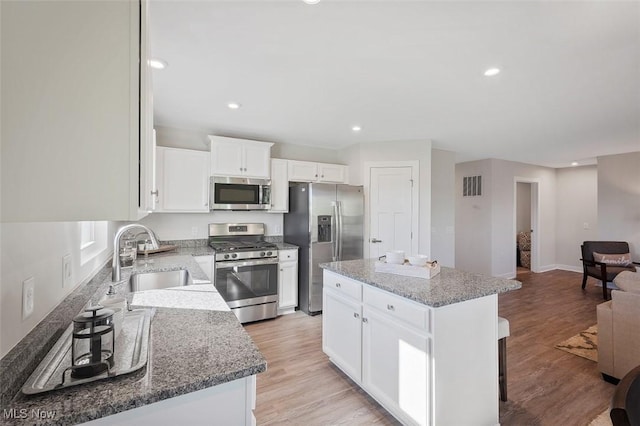 149 Hidden Village Dr Unit S/L 152, Perry, OH 44081 - kitchen with appliances with stainless steel finishes, a sink, a center island, light stone counters, and recessed lighting