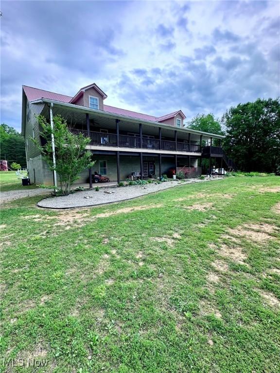 10664 W Little Kanawha Hwy, Mount Zion, WV 26151 - rear view of house featuring a lawn and a wooden deck