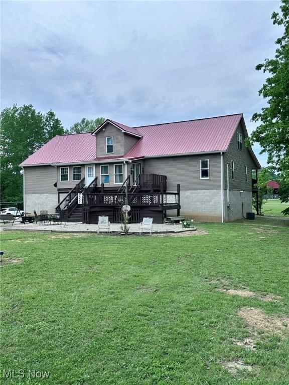 10664 W Little Kanawha Hwy, Mount Zion, WV 26151 - rear view of house with metal roof, a yard, and a wooden deck