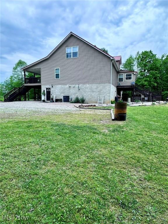 10664 W Little Kanawha Hwy, Mount Zion, WV 26151 - view of property exterior with stairway, a lawn, and a wooden deck