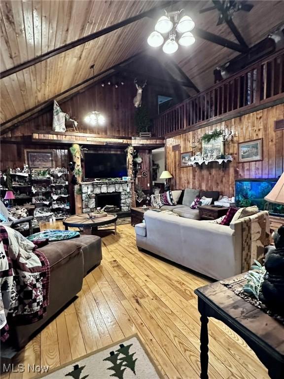 10664 W Little Kanawha Hwy, Mount Zion, WV 26151 - living area featuring wood walls, vaulted ceiling, a fireplace, wood-type flooring, and wooden ceiling