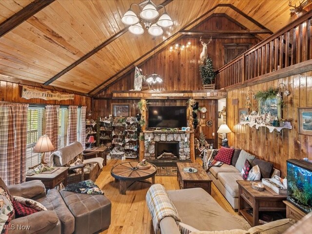 10664 W Little Kanawha Hwy, Mount Zion, WV 26151 - living room with wood walls, a chandelier, wood ceiling, hardwood / wood-style floors, and high vaulted ceiling
