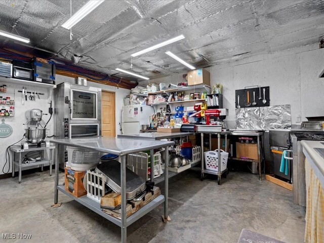 10664 W Little Kanawha Hwy, Mount Zion, WV 26151 - kitchen featuring concrete flooring and freestanding refrigerator