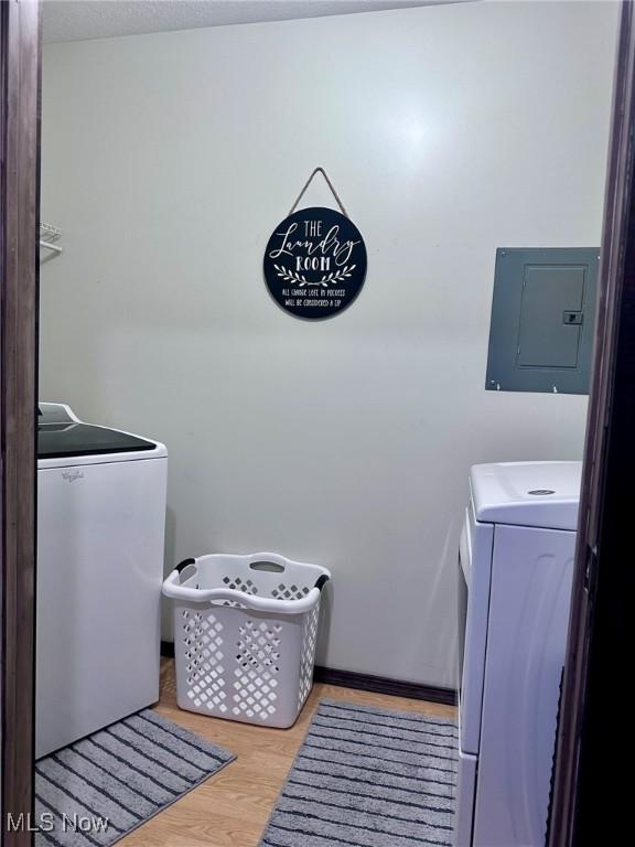 10664 W Little Kanawha Hwy, Mount Zion, WV 26151 - laundry area featuring electric panel, washing machine and clothes dryer, and wood finished floors