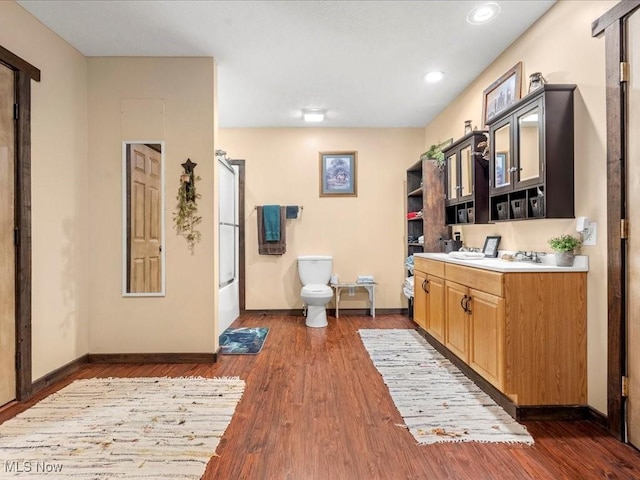 10664 W Little Kanawha Hwy, Mount Zion, WV 26151 - bathroom with toilet, vanity, baseboards, wood finished floors, and recessed lighting
