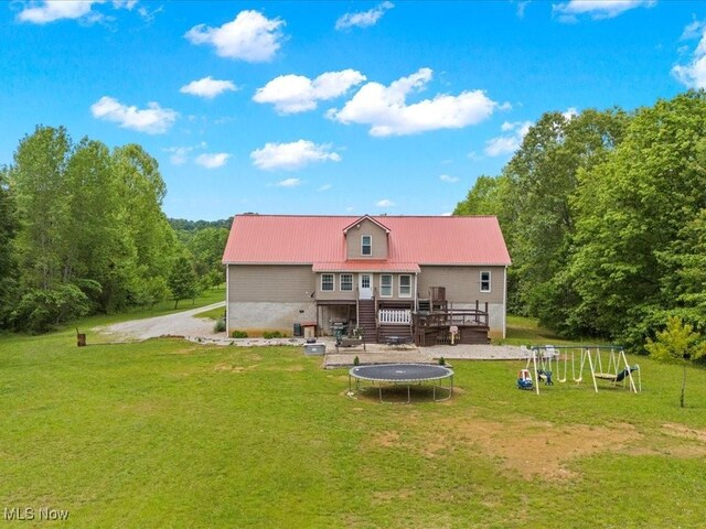 10664 W Little Kanawha Hwy, Mount Zion, WV 26151 - back of property with a deck, a yard, a trampoline, and metal roof