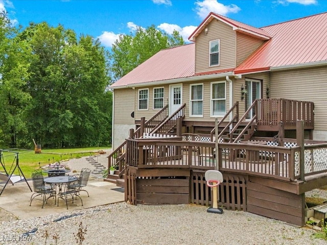 10664 W Little Kanawha Hwy, Mount Zion, WV 26151 - back of property featuring stairway, a wooden deck, a patio area, and metal roof
