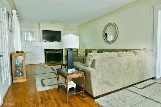 2816 E Market St, Warren, OH 44483 - living room featuring ornamental molding, wood finished floors, and a tiled fireplace