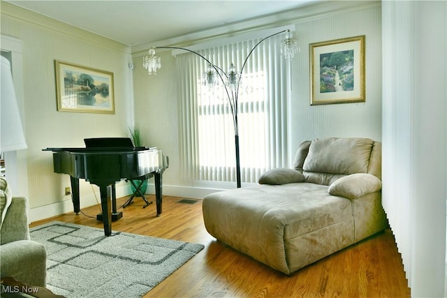 2816 E Market St, Warren, OH 44483 - sitting room with crown molding, a chandelier, wood finished floors, and baseboards