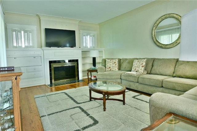 2816 E Market St, Warren, OH 44483 - living room featuring crown molding, wood finished floors, a tiled fireplace, and plenty of natural light