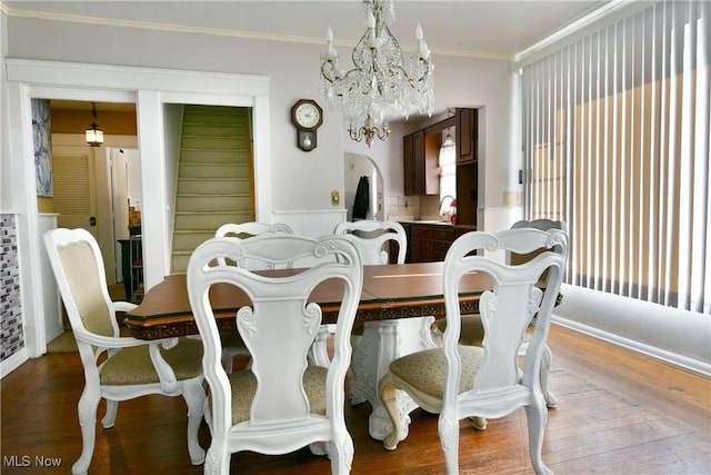 2816 E Market St, Warren, OH 44483 - dining room with a chandelier, ornamental molding, wood finished floors, and stairs