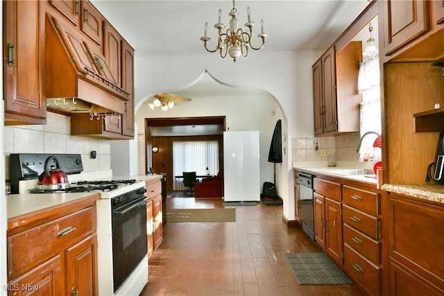 2816 E Market St, Warren, OH 44483 - kitchen with gas stove, dishwasher, light countertops, backsplash, and a chandelier
