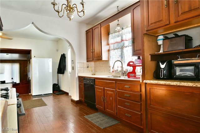 2816 E Market St, Warren, OH 44483 - kitchen with white appliances, a chandelier, light countertops, and healthy amount of natural light