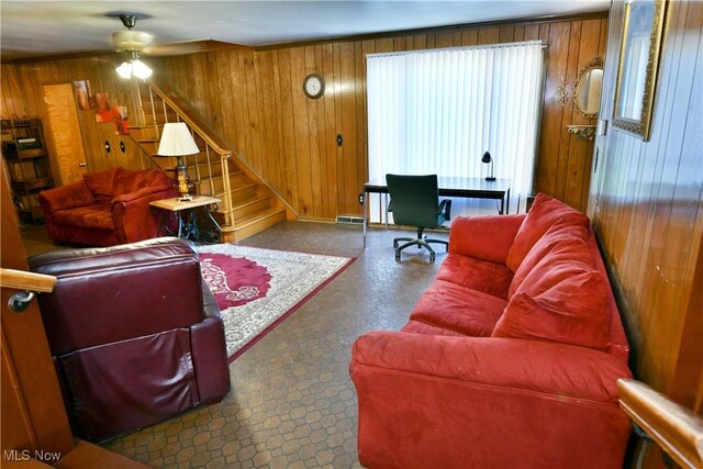 2816 E Market St, Warren, OH 44483 - living area featuring wooden walls, a ceiling fan, tile patterned floors, stairs, and baseboards