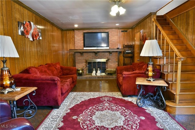 2816 E Market St, Warren, OH 44483 - living area featuring wood walls, stairway, a brick fireplace, a ceiling fan, and ornamental molding