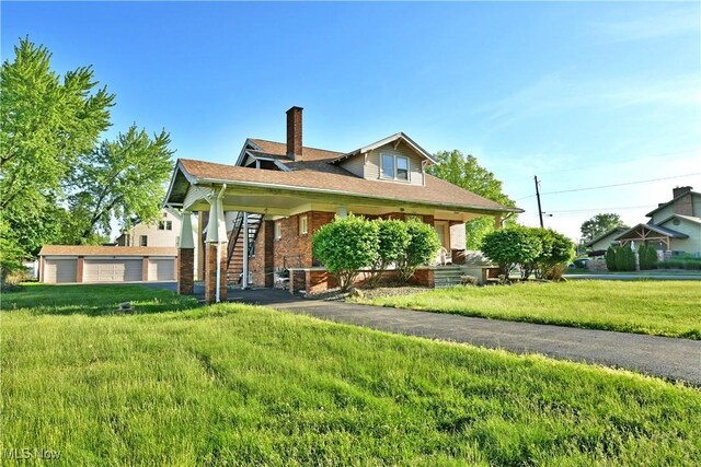 2816 E Market St, Warren, OH 44483 - view of front of home with a chimney, a front lawn, covered porch, and brick siding