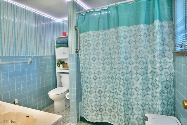 2816 E Market St, Warren, OH 44483 - bathroom with tile walls, toilet, a shower with shower curtain, and vanity